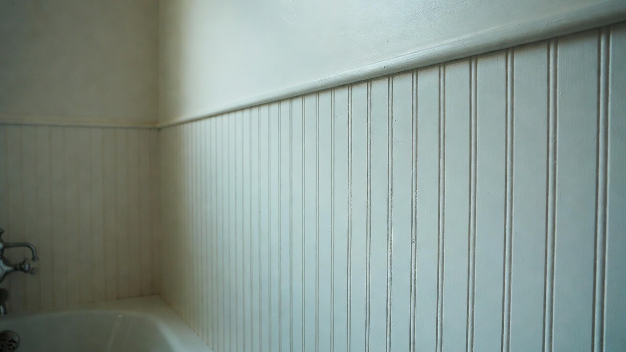 A close-up shot of beadboard paneling inside a modern bathroom.